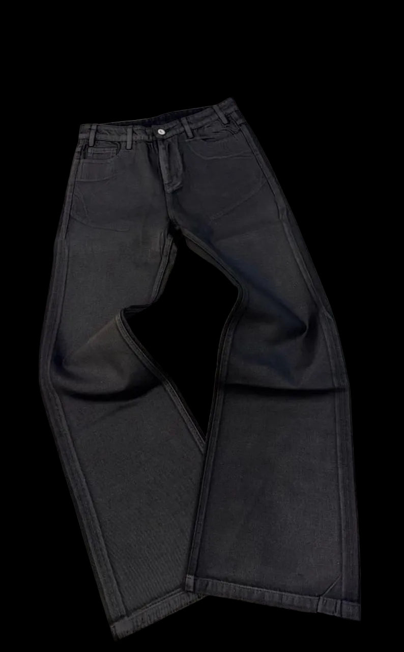 Black jeans on a white surface with a blurred background