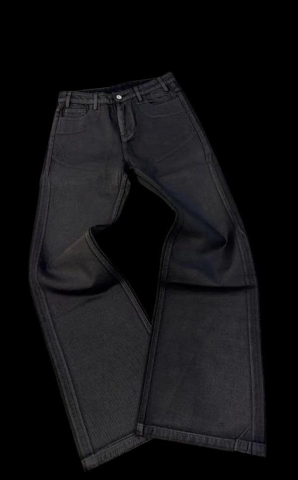 Black jeans on a white surface with a blurred background