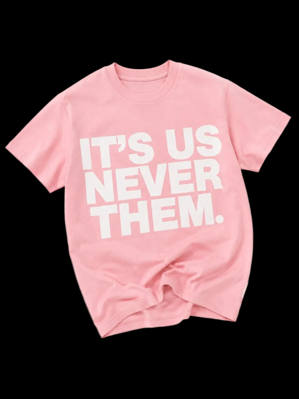 Pink t-shirt with white text 'IT'S US NEVER THEM' on a white background