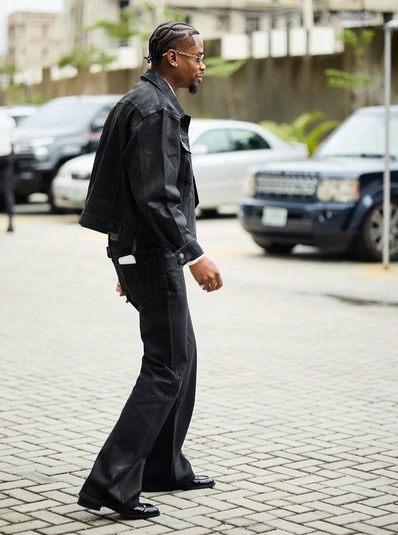 Yhemo Lee wearing Black Wax Denim Set walking on a street 