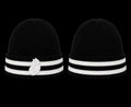 Two black beanie hats with white stripes and a logo on a white background